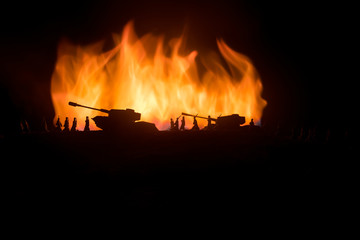 War Concept. Military silhouettes fighting scene on war fog sky background, World War German Tanks Silhouettes Below Cloudy Skyline At night. Attack scene. Armored vehicles.