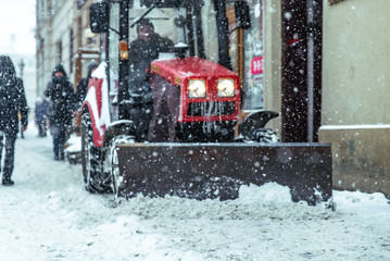 snowstorm in city. cleaning streets of snow