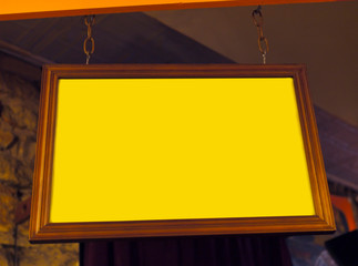 Wall Mural - Empty yellow hanging indoor sign. Copy space.