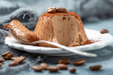 Coffee Panna cotta on a plate close-up.