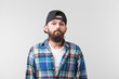 © satura_ - Beauty, fashion and people concept - Portrait of a young bearded hipster stylish guy over white background.