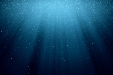 Wall Mural - abstract background with motion of shining blinking particles on blue background with rays of light.