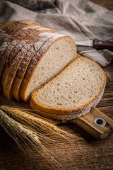 Wall Mural - Sliced loaf of bread on a chopping board.