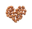 Grain buckwheat closeup isolated on white background. In the shape of a heart.