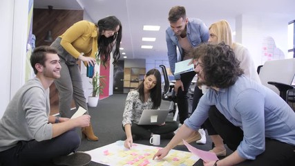 Wall Mural - Young colleagues shaking their hands after successful project. Tech office, tech company, tech startup, tech team.