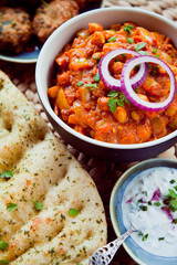 Wall Mural - Chickpea Tomato Vegetarian, Vegan, Plant Based Curry  -  Chana Masala with Naan Bread. Chana masala, also known as channay, chole masala, chole or chholay, is a dish originating from the India.