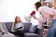 © Andrey Popov - Mother Shouting Through Megaphone At Girl Using Digital Tablet