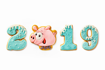 Wall Mural - Gingerbread caption 2019 made of symbol of New year - pink pig and numbers isolated at white background.