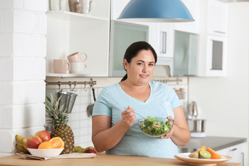 Poster - Woman with bowl of vegetable salad in kitchen. Healthy diet