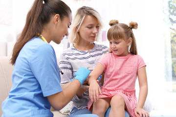 Wall Mural - Children's doctor vaccinating little girl at home