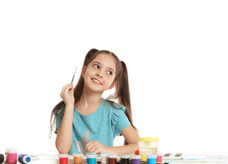 Sticker - Cute child painting picture at table on white background