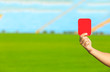 Football referee showing red card at stadium, closeup with space for text