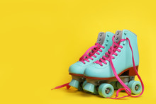Pair Of Stylish Quad Roller Skates On Color Background. Space For Text