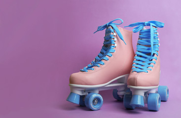 Wall Mural - pair of stylish quad roller skates on color background. space for text