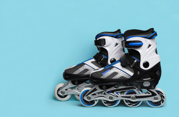 Wall Mural - pair of inline roller skates on color background. space for text