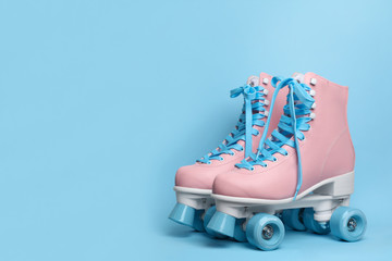 Wall Mural - pair of stylish quad roller skates on color background. space for text