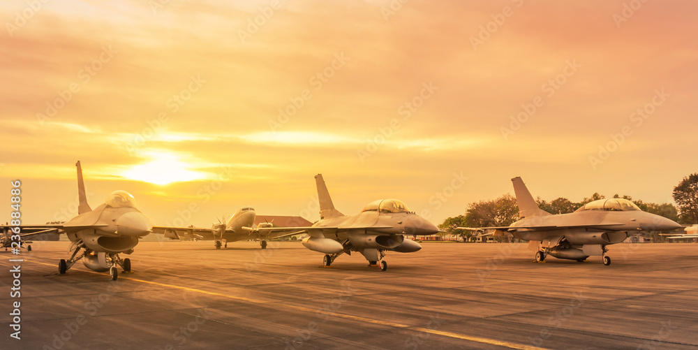Falcon fighter jet military aircraft parked on runway in the base airforce standby ready to take off for military mission on sunset - obrazy, fototapety, plakaty 
