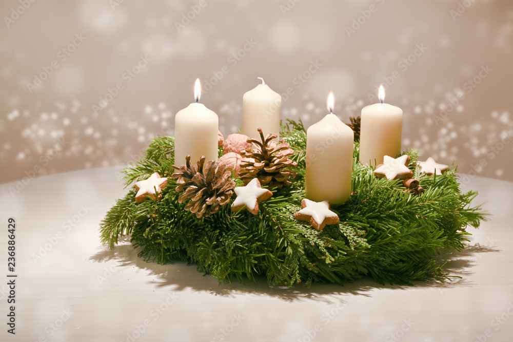 Third Advent - decorated Advent wreath from fir and evergreen branches with white burning candles, tradition in the time before Christmas, warm background with festive bokeh and copy space - obrazy, fototapety, plakaty 