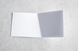 © ooddysmile - Blank portrait mock-up paper. brochure magazine isolated on gray, changeable background / white paper isolated on gray cement backdrop.
