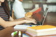 © Pormezz - female asian student studying and reading book in library