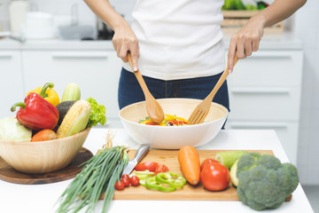 Wall Mural - Eat healthy food for good wellness health concept. Woman cooking salad menu with fresh organic vegetables