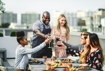 Gorgeous friends toasting at a summer party