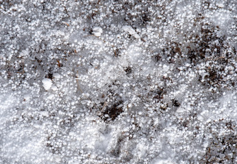 Hail and snow on frozen ground