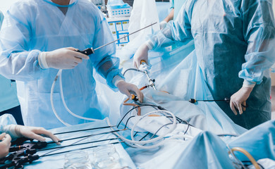 Wall Mural - Process of gynecological surgery operation using laparoscopic equipment. Group of surgeons in operating room with surgery equipment