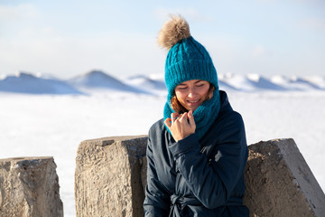 Wall Mural - Fashion lifestyle portrait of young trendy woman dressed in warm stylish clothes  laughing and smiling in the  winter mountains.  portrait of joyful woman