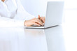 © rogerphoto - Close-up of business woman hands typing on laptop computer. Secretary at work in office