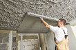 © Kadmy - Plasterer smoothing plaster mortar on ceiling with screeder