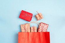 Red Shopping Bag With Gifts On A Blue Background.