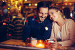 © NDABCREATIVITY - Romantic couple dating in pub at night