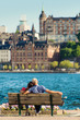 © lenaivanova2311 - Couple on a bench, summer view of the Old Town pier architecture in Stockholm. Sweden