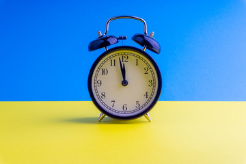 Clock on colorful background with selective focus and crop fragment. Copy space concept