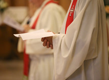 Priest With A Cassock And Hands Joined In Prayer