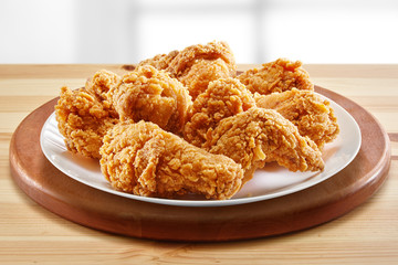 crispy coated batter southern style fried chicken in a wooden table