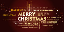 Merry Christmas Greeting Card With Golden Letters In Different Languages On Brown Background