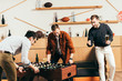 © LIGHTFIELD STUDIOS - man looking at young friends playing table soccer in cafe
