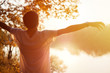 © pavelkant - A young man enjoys the sun and rest at sunset.