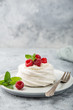 mini pavlova  meringue cake with whipped cream and fresh raspberry