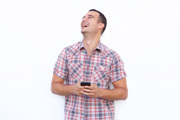 older man laughing with mobile phone and looking up against isolated white background