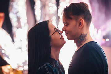 guy and the girl kiss closeup on a light background.