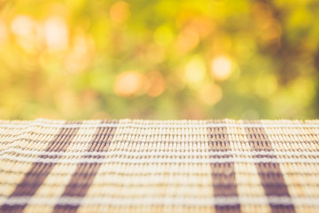Table with stripes in front of unfocused background. Perspective with more blur on the background.