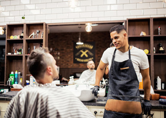 Wall Mural - A man client talking to haidresser and hairstylist in barber shop.