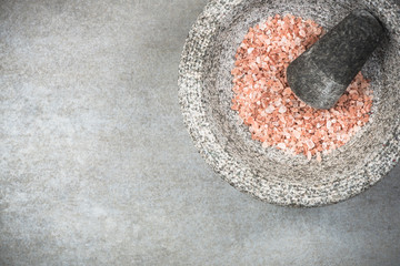 Wall Mural - Himalayan pink salt seed in granite mortar or pestle