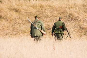 Wall Mural - The hunter in the hunting clothes and with rifle hunts