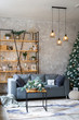 © sergiophoto - Interior of modern living room with comfortable sofa decorated with Christmas tree and gifts