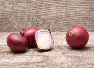 Fresh red onion on wooden background