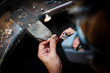 © photoflorenzo - Jeweler saws at a gold ring in authentic jewellery workshop